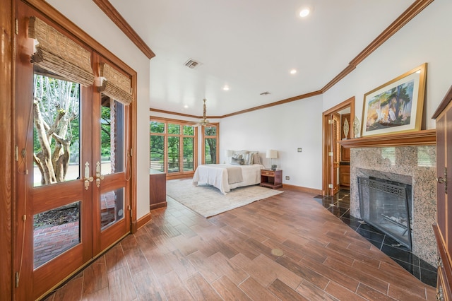 unfurnished bedroom with dark hardwood / wood-style flooring, ornamental molding, french doors, and a fireplace