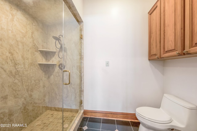 bathroom with tile flooring, walk in shower, and toilet