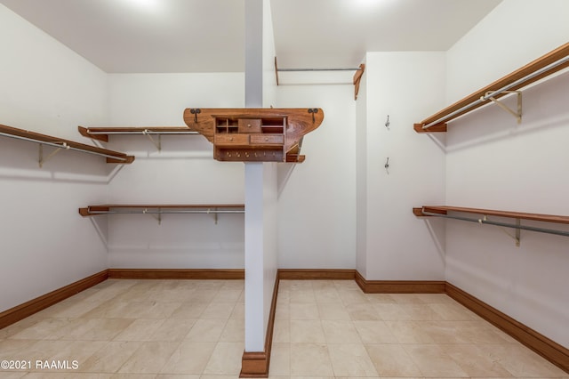 spacious closet with light tile floors