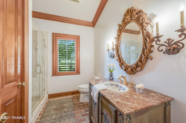 bathroom featuring a shower with shower door, vanity, toilet, and crown molding