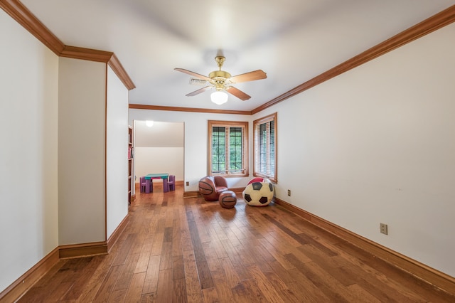 sitting room featuring ornamental molding, wood-type flooring, and ceiling fan