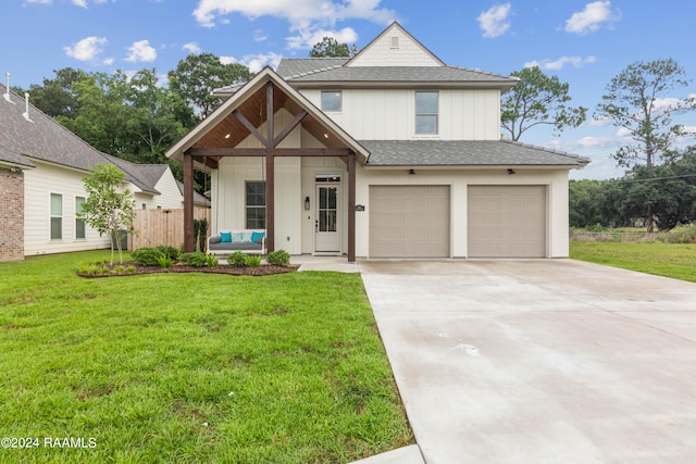 view of front of house with a front yard and a garage