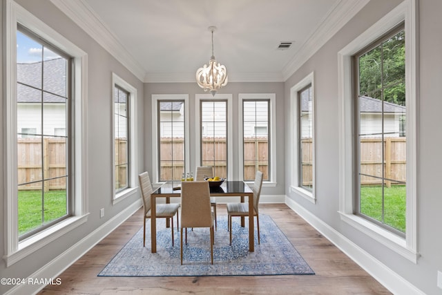 sunroom featuring a wealth of natural light and a chandelier