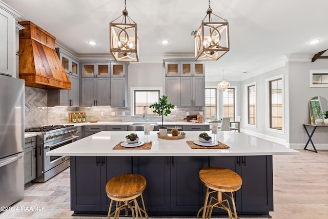 kitchen with gray cabinetry, a large island, and stainless steel appliances