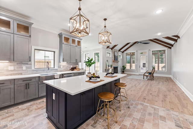 kitchen featuring a center island, gray cabinets, light hardwood / wood-style flooring, and a wealth of natural light