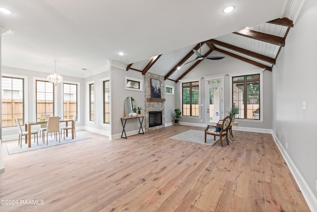 unfurnished living room with lofted ceiling with beams, a fireplace, wood ceiling, ceiling fan with notable chandelier, and light wood-type flooring