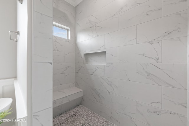 bathroom with tiled shower