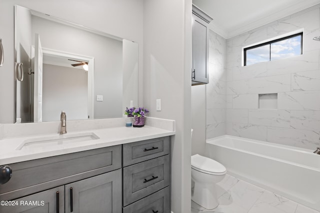 full bathroom featuring ornamental molding, vanity, ceiling fan, toilet, and tiled shower / bath