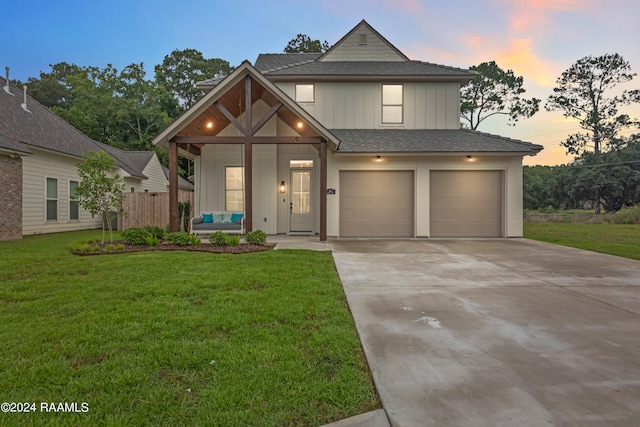 view of front of house with a garage and a yard