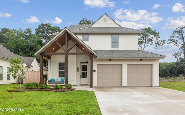 view of front of home with a garage and a front lawn