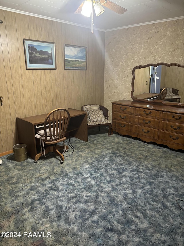 living area featuring dark carpet, ceiling fan, ornamental molding, and wood walls