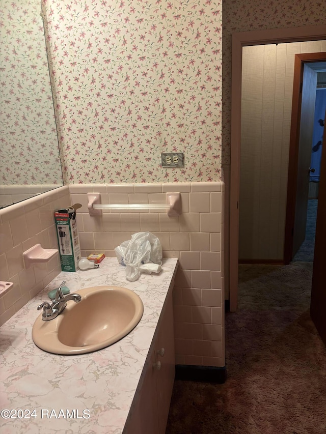 bathroom featuring vanity and tile walls