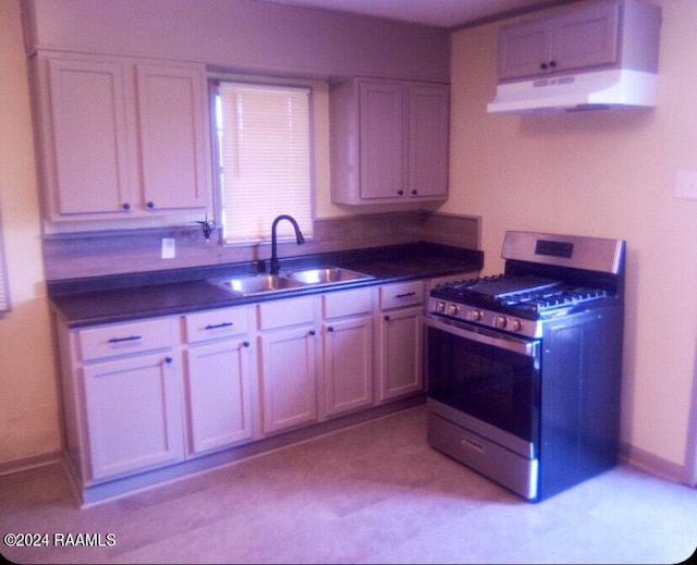 kitchen featuring sink, premium range hood, and range with gas cooktop