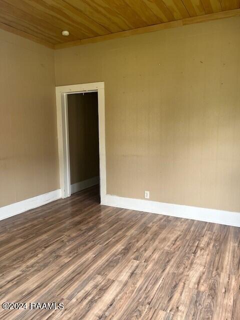 unfurnished room featuring hardwood / wood-style flooring and wooden ceiling