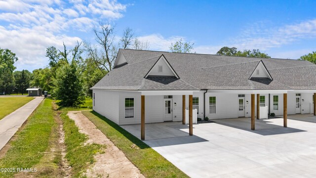 210 E D St, Rayne, LA 70578 - view of front of home featuring roof with shingles, a carport, and concrete driveway