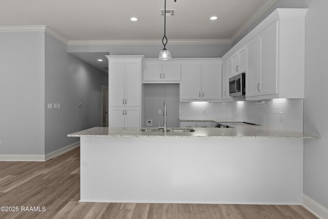 210 E D St, Rayne, LA 70578 - kitchen featuring white cabinets, visible vents, a sink, and stainless steel microwave