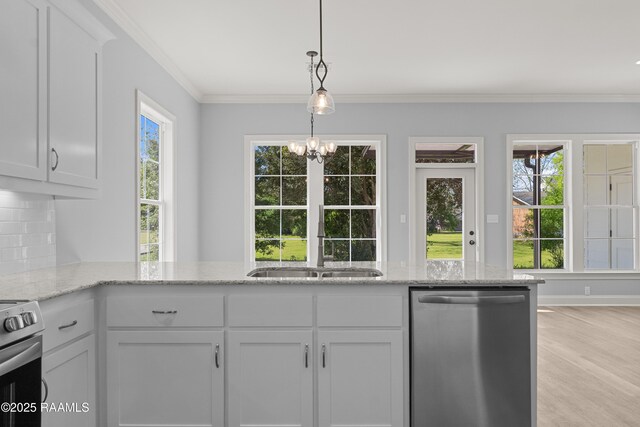 210 E D St, Rayne, LA 70578 - kitchen featuring stainless steel appliances, a sink, light stone counters, and a healthy amount of sunlight