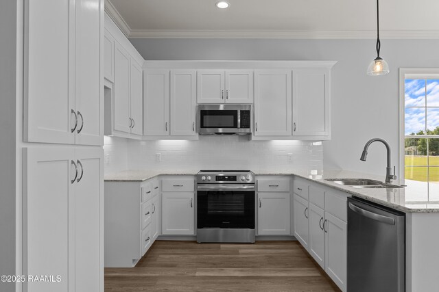 210 E D St, Rayne, LA 70578 - kitchen with stainless steel appliances, a sink, white cabinetry, and ornamental molding