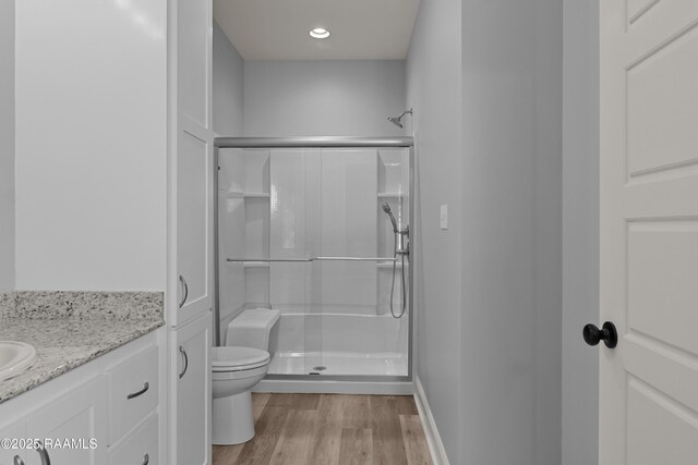 210 E D St, Rayne, LA 70578 - bathroom with toilet, wood finished floors, vanity, and a stall shower