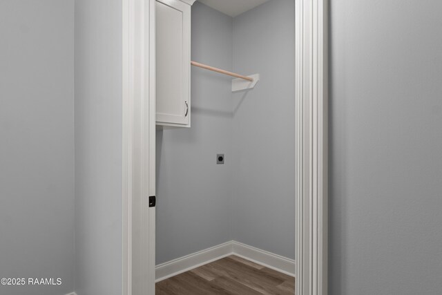 210 E D St, Rayne, LA 70578 - laundry area featuring electric dryer hookup, cabinet space, dark wood-style floors, and baseboards