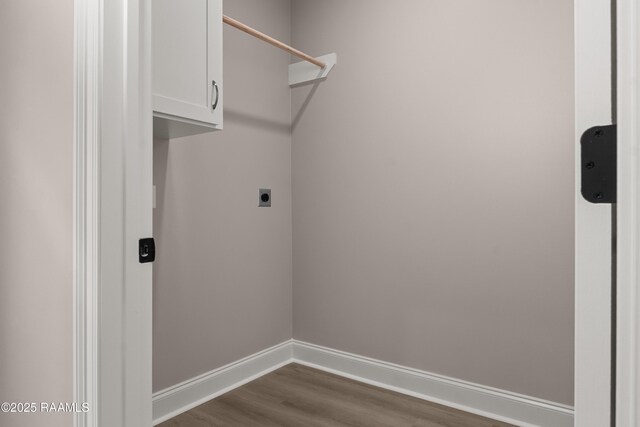 210 E D St, Rayne, LA 70578 - clothes washing area with baseboards, cabinet space, electric dryer hookup, and dark wood-type flooring