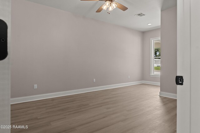 210 E D St, Rayne, LA 70578 - unfurnished room with recessed lighting, wood finished floors, visible vents, a ceiling fan, and baseboards