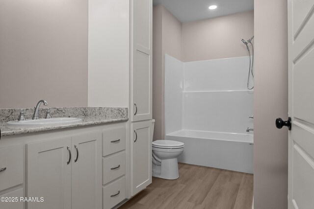 210 E D St, Rayne, LA 70578 - full bathroom with toilet, vanity, wood finished floors, and tub / shower combination