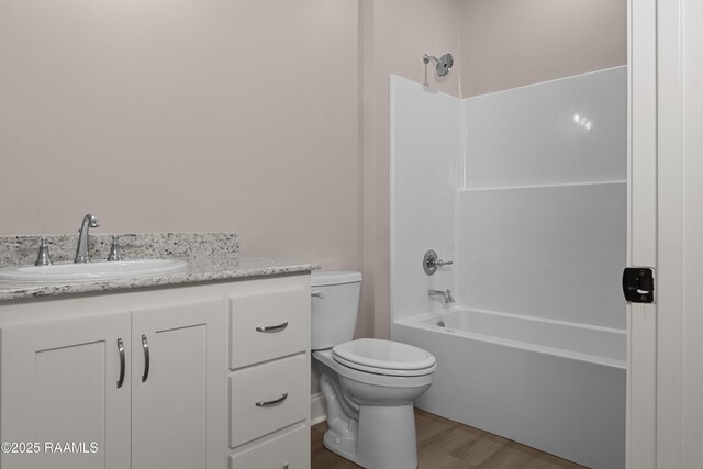 210 E D St, Rayne, LA 70578 - bathroom with toilet, shower / bathtub combination, vanity, and wood finished floors