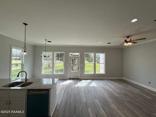 kitchen featuring a sink, ornamental molding, open floor plan, and dishwasher