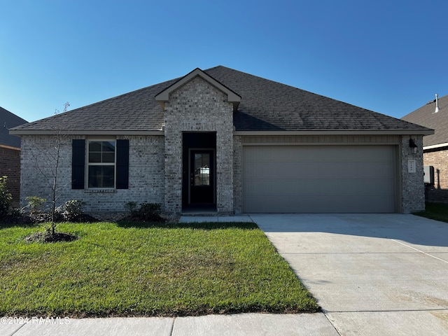 view of front facade with a front lawn and a garage