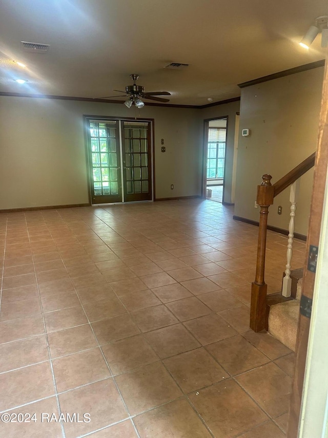 spare room with ceiling fan and light tile flooring