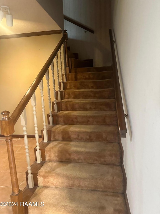 stairs featuring tile flooring