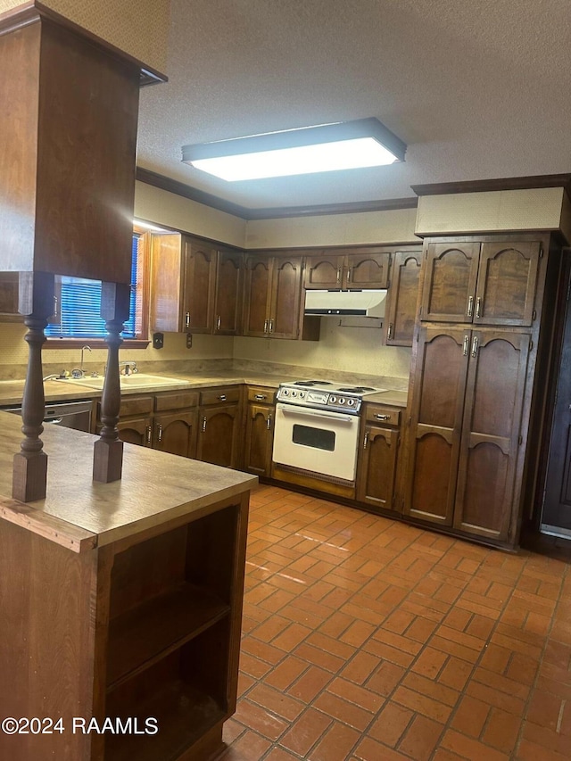 kitchen with a textured ceiling, white range with gas cooktop, and dark brown cabinets