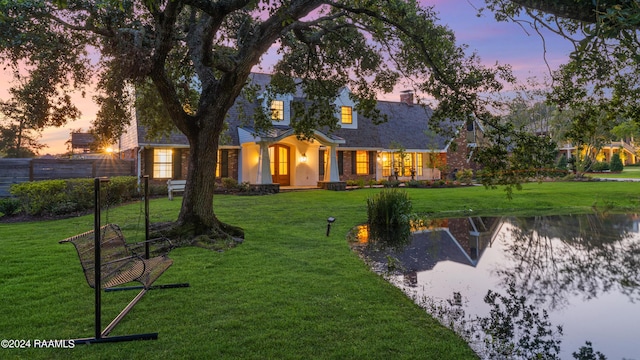 120 Kimball Dr, Lafayette, LA 70508 - view of front of house featuring a lawn and a water view