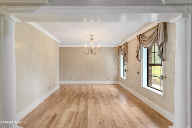 unfurnished dining area with light hardwood / wood-style floors, an inviting chandelier, and crown molding