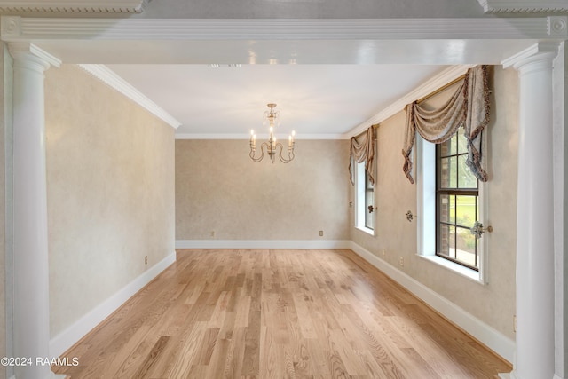 120 Kimball Dr, Lafayette, LA 70508 - unfurnished dining area featuring light wood-style floors, a chandelier, crown molding, ornate columns, and baseboards