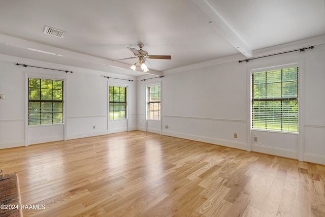 spare room featuring beamed ceiling, ceiling fan, light hardwood / wood-style floors, and ornamental molding