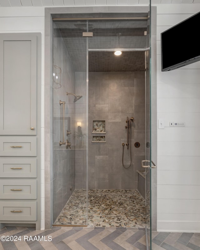 bathroom featuring a shower with shower door