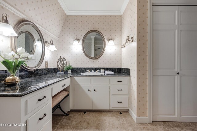 bathroom featuring tile patterned flooring, vanity, and crown molding