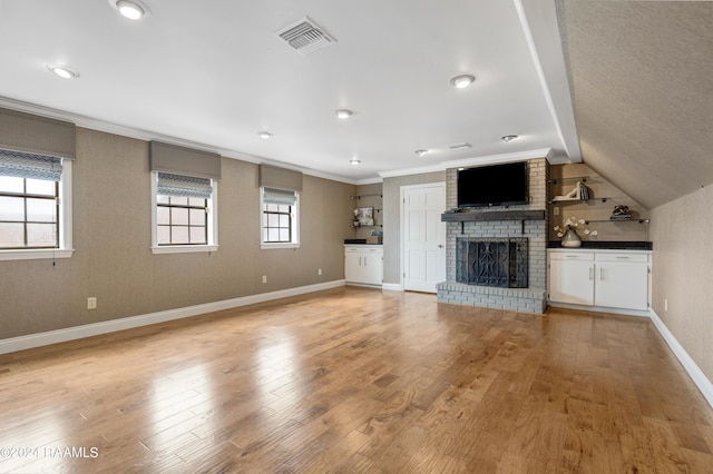 120 Kimball Dr, Lafayette, LA 70508 - unfurnished living room featuring a brick fireplace, baseboards, light wood finished floors, crown molding, and lofted ceiling