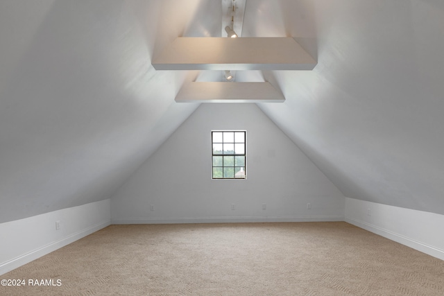 bonus room featuring light colored carpet and vaulted ceiling