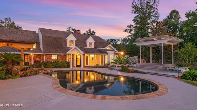 pool at dusk with a patio