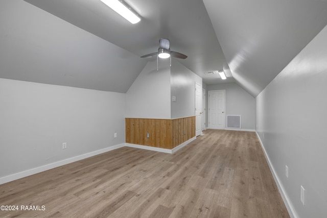 additional living space featuring ceiling fan, light wood-type flooring, and vaulted ceiling