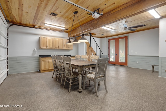 dining space with ceiling fan, wooden ceiling, wooden walls, and french doors