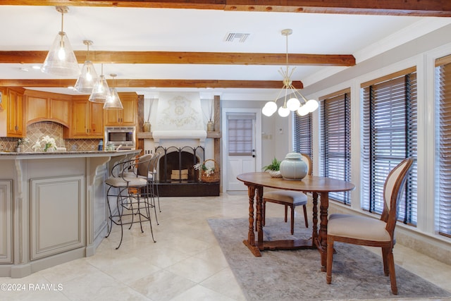 tiled dining space with a large fireplace, beamed ceiling, a chandelier, and ornamental molding