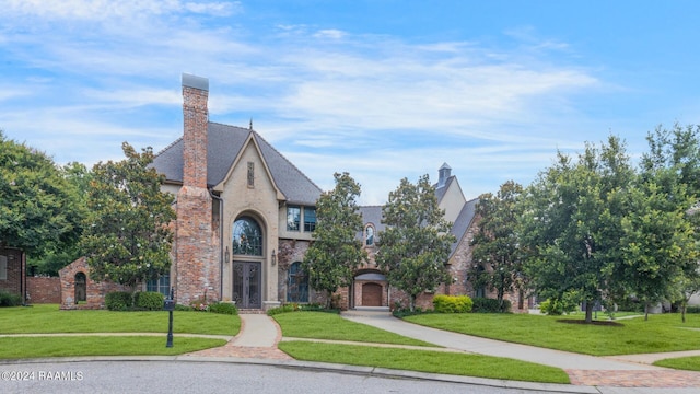 tudor home featuring a front yard