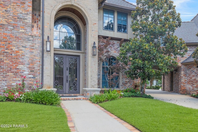 property entrance with a yard and french doors