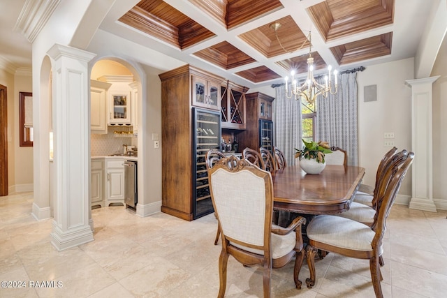 dining area featuring beamed ceiling, ornamental molding, ornate columns, and coffered ceiling