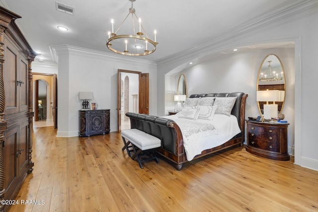 bedroom featuring a notable chandelier, light hardwood / wood-style floors, and crown molding