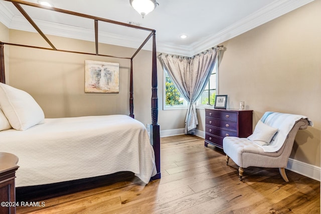 bedroom with hardwood / wood-style flooring and crown molding